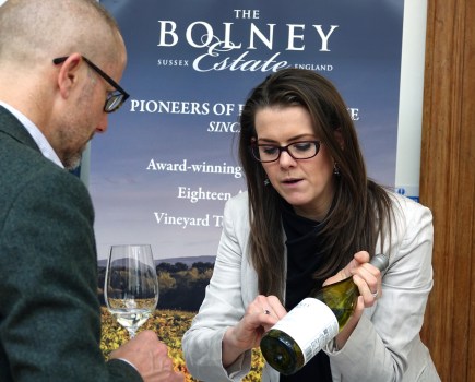 woman showing wine bottle to man