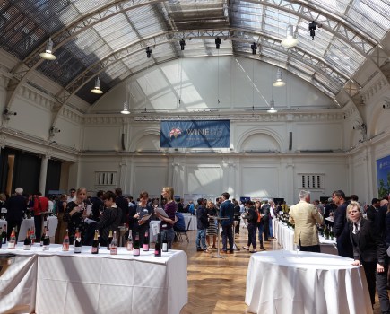 Hall full of people wine tasting