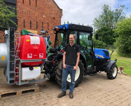 Person in front of a sprayer